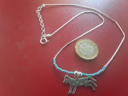 Silver running wolf necklace with paw prints 1